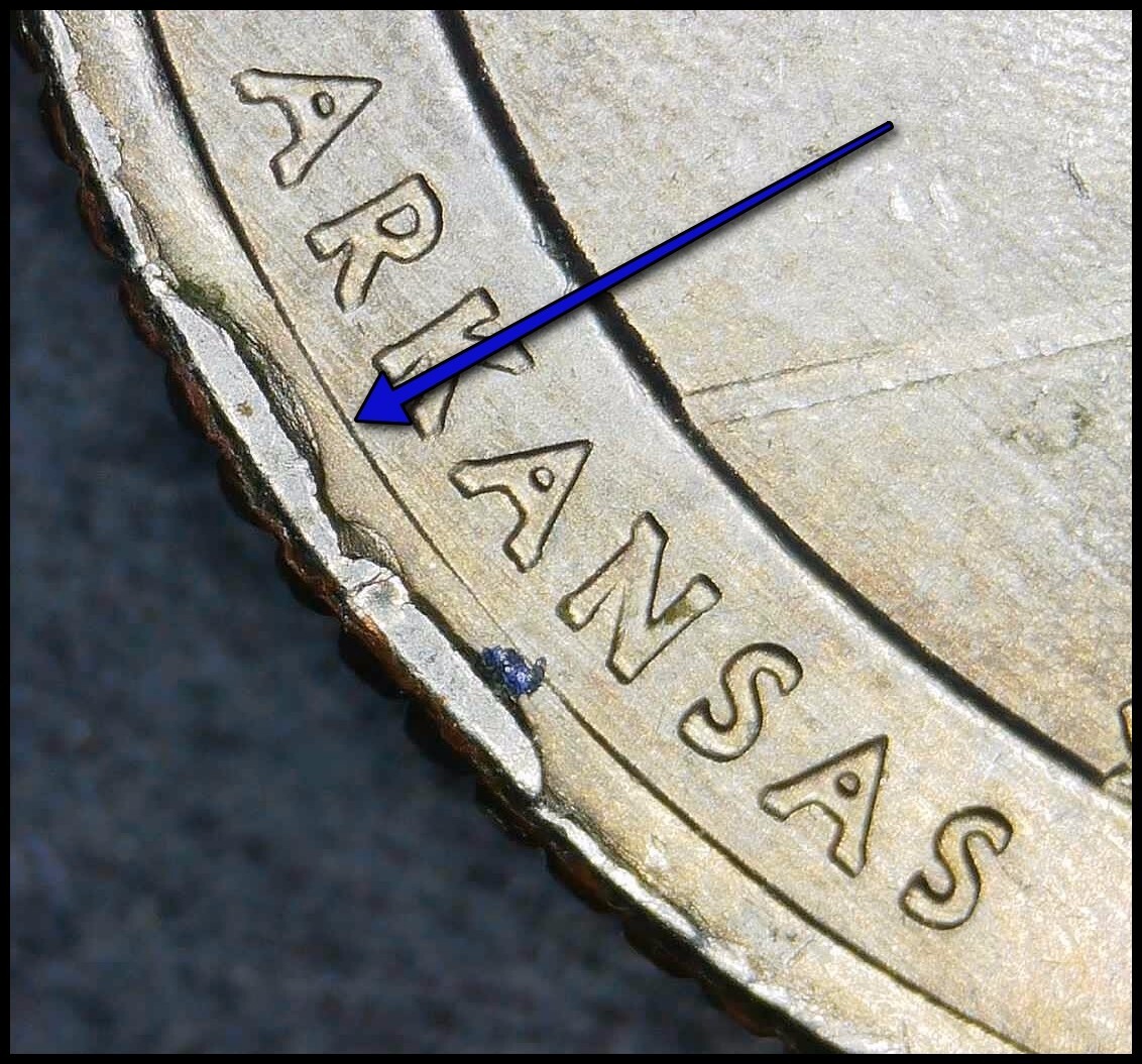 2010 Hot Springs quarter rim cud error showing raised formless blob at the coin edge